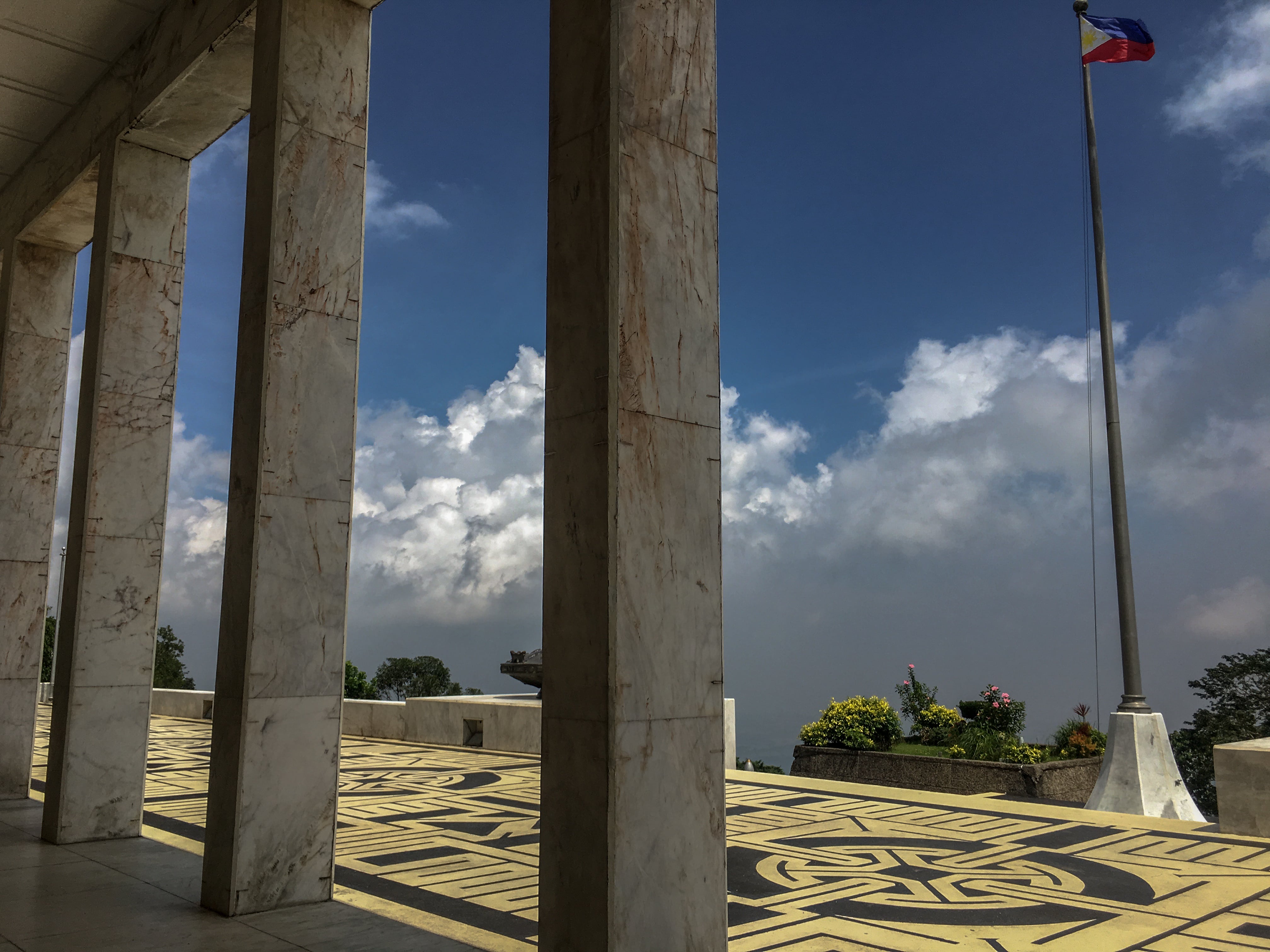 philippine flag at collonade at shrine of valor at mount samat in bataan